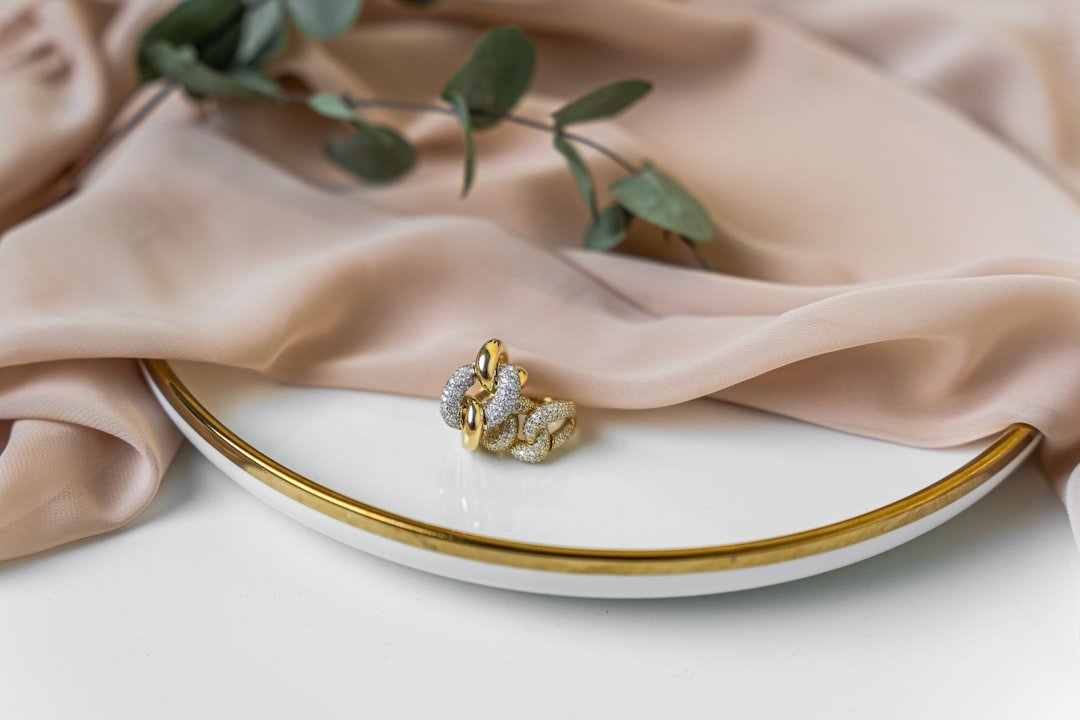 Gold ring styled on a warm neutral plate